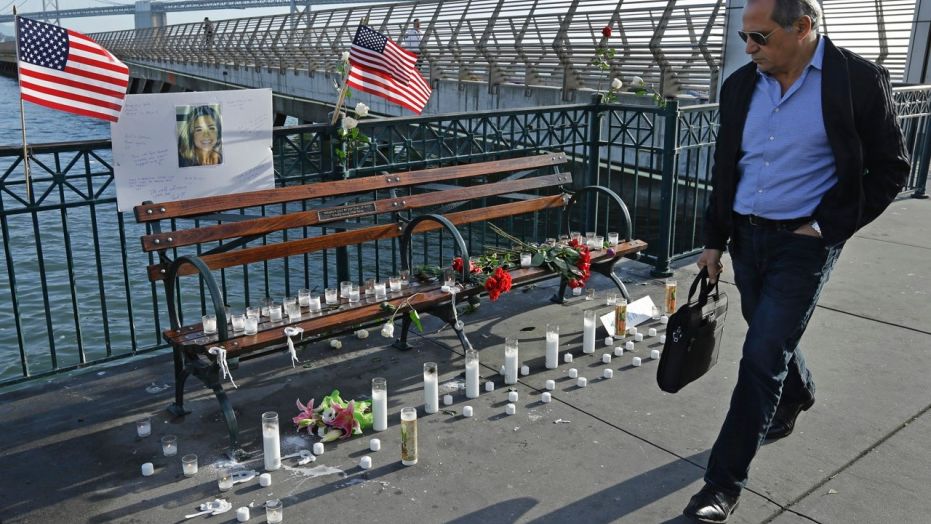 Dec. 1: A pedestrian passes the memorial to Kate Steinle at Pier 14 in San Francisco. The city reportedly removed the candles at Steinle's family's request.