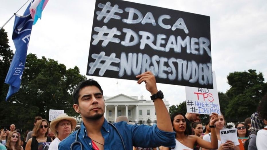 Carlos Esteban and other supporters of the DREAM Act and DACA demonstrate outside the White House in Washington, Sept. 5, 2017.