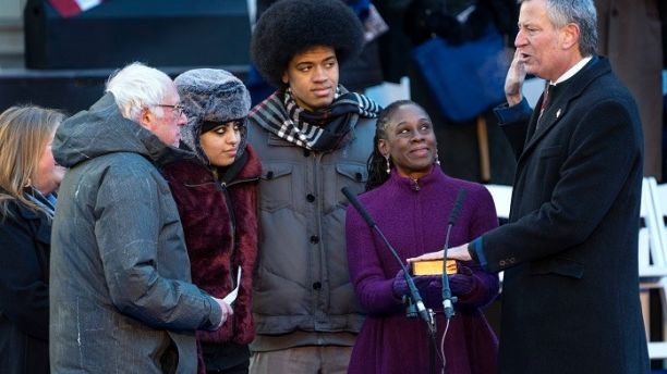 U.S. Sen. Bernie Sanders, I-Vt., left, swears in New York Mayor Bill de Blasio for a second term as mayor at City Hall in New York, Monday, Jan. 1, 2018. With De Blasio, second from left, are his daughter Chiara, son Dante, and wife, Chirlane McCray. (AP Photo/Craig Ruttle)