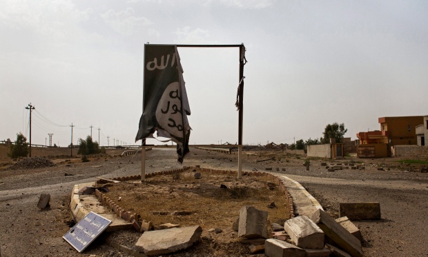 Mideast Iraq ISIS banner Qayara oil wells 