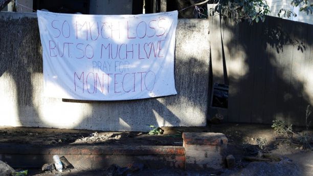 A sign is placed on a fence in the aftermath of a devastating mudslide Saturday, Jan. 13, 2018, in Montecito, Calif. Most of the people of Montecito, a town usually known for its serenity and luxury, were under orders to stay out of town as gas and power were expected to be shut off Saturday for repairs. (AP Photo/Marcio Jose Sanchez)
