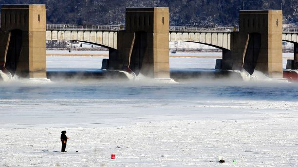 A person fishes near Lock and Dam No. 11 in Dubuque, Iowa, on Monday, Jan. 1, 2018. The area is seeing bitterly cold temperatures to start the new year. (Nicki Kohl/Telegraph Herald via AP)
