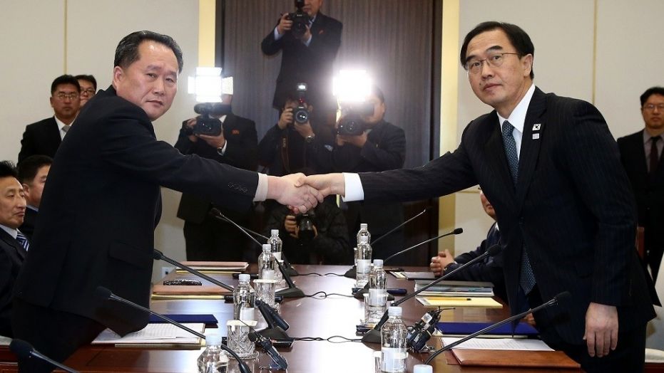 South Korean Unification Minister Cho Myoung-gyon, right, shakes hands with the head of North Korean delegation, Ri Son Gwon, during their meeting at the Panmunjom in the Demilitarized Zone in Paju, South Korea, Jan. 9, 2018.