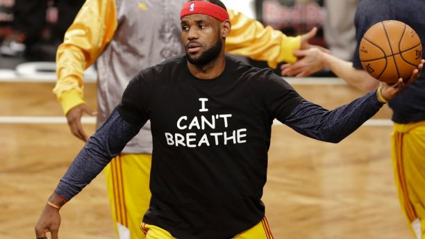 FILE - In this Dec. 8, 2014 file photo, Cleveland Cavaliers' LeBron James wears a T-shirt reading