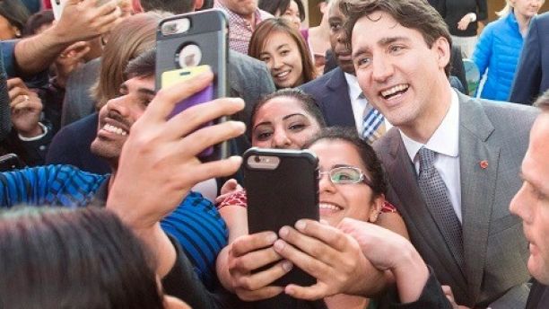 Prime Minister Justin Trudeau poses for photos with employees as he leaves the offices of Salesforce on Thursday, Feb. 8, 2018 in San Francisco. (Ryan Remiorz/The Canadian Press via AP)