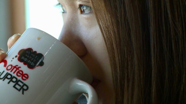 Young Woman Drinking Coffee