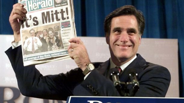 Republican Mitt Romney holds up a Boston newspaper announcing his victory in the Massachusetts Governor's race during his acceptance speech, November 5, 2002 in Boston. Former Salt Lake City 2002 Winter Olympics chief Romney beat [Democratic candidate Shannon O'Brien.] - PBEAHUKOKDZ