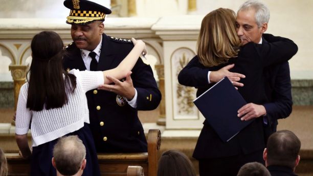 Chicago police Superintendent Eddie Johnson hugs Grace Bauer, 13, as Mayor Rahm Emanuel hugs Erin Bauer during the funeral mass of Chicago police Commander Paul Bauer at Nativity of Our Lord Roman Catholic Church Saturday, Feb. 17, 2017, in Chicago. Bauer died Tuesday when he was shot six times while pursuing a suspect he was attempting to detain downtown Chicago. Officials have charged 44-year-old Shomari Legghette with the 53-year-old commander's killing.   (John J. Kim/Chicago Tribune via AP)