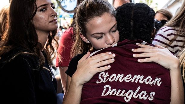 Students from Marjory Stoneman Douglas High School attend a memorial following a school shooting incident in Parkland, Florida, U.S., February 15, 2018.  REUTERS/Thom Baur - RC1AFD9727E0