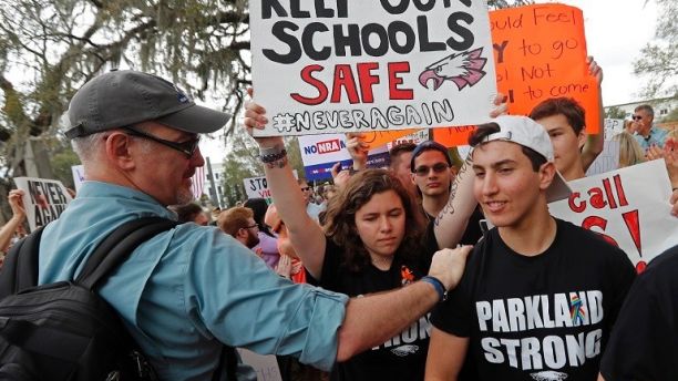 FILE - In this Wednesday, Feb. 21, 2018 file photo, student survivors from Marjory Stoneman Douglas High School are greeted as they arrive at a rally for gun control reform on the steps of the state capitol, in Tallahassee, Fla. Dozens of college and universities are telling students who may face discipline at their high schools for participating in gun control demonstrations to relax: It won't affect their chances of getting into their schools. Nearly 50 schools including Yale, Dartmouth and UCLA have taken to social media to reassure the students. (AP Photo/Gerald Herbert, File)