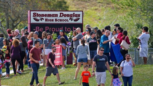 Parents and students arrive at Marjory Stoneman Douglas High School for an open house on Sunday, Feb. 25, 2018, in Parkland, Fla., as parents and students returned to the school for the first time since over a dozen were killed on Feb. 14. (David Santiago/Miami Herald via AP)