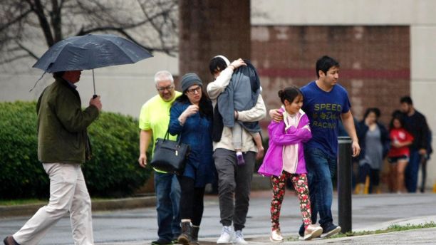 People exit the Dalton Convention Center on Wednesday, Feb. 28, 2018 in Dalton, Ga. Students from Dalton High School were evacuated to the Dalton Convention Center after social studies teacher Randal Davidson allegedly barricaded himself in a classroom and fired a handgun. (C.B. Schmelter/Chattanooga Times Free Press via AP)