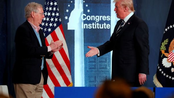 U.S. President Donald Trump shakes hands with Senate Majority Leader Mitch McConnell (R-KY) after addressing the Republican congressional retreat at the Greenbrier resort in White Sulphur Springs, West Virginia, U.S. February 1, 2018. REUTERS/Jonathan Ernst - RC1885C9ED40