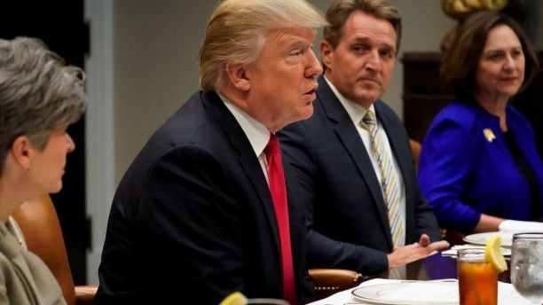 U.S. President Donald Trump, flanked by U.S. Senator Joni Ernst, Senator Jeff Flake and Senator Deb Fischer, speaks to reporters prior to a lunch meeting with Senate Republicans at the White House in Washington, U.S. December 5, 2017.  REUTERS/Jonathan Ernst - RC1551F924D0