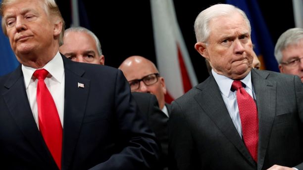 U.S. President Donald Trump and Attorney General Jeff Sessions button their coats as they stand for the national anthem at a graduation ceremony at the FBI Academy on the grounds of Marine Corps Base Quantico in Quantico, Virginia, U.S. December 15, 2017.  REUTERS/Jonathan Ernst - RC1C8E4C7070
