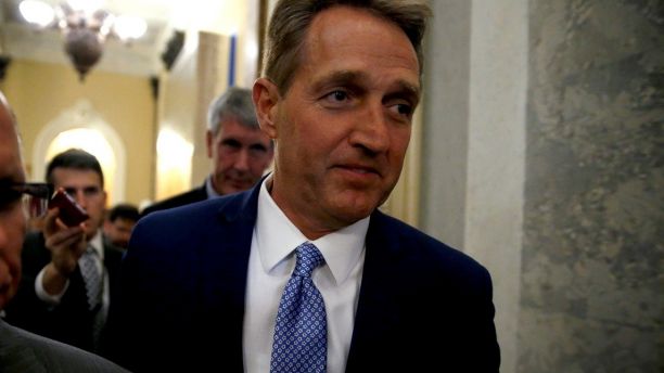 U.S. Senator Jeff Flake (R-AZ) walks past journalists after announcing he will not run for reelection on Capitol Hill in Washington, DC, U.S. October 24, 2017. REUTERS/Joshua Roberts - RC115CA83EE0