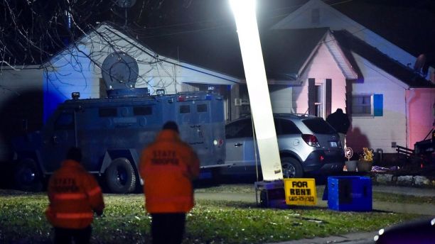 Law enforcement officials respond to the scene of a shooting where officer Christopher Ryan Morton was killed and two other officers wounded as they responded to a 911 call on Tuesday evening, March 6, 2018, in Clinton, Mo. (Keith Myers/The Kansas City Star via AP)