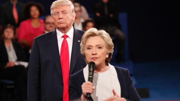 Republican U.S. presidential nominee Donald Trump listens as Democratic nominee Hillary Clinton answers a question from the audience during their presidential town hall debate at Washington University in St. Louis, Missouri, U.S., October 9, 2016. REUTERS/Rick Wilking - HT1ECAA055M6E